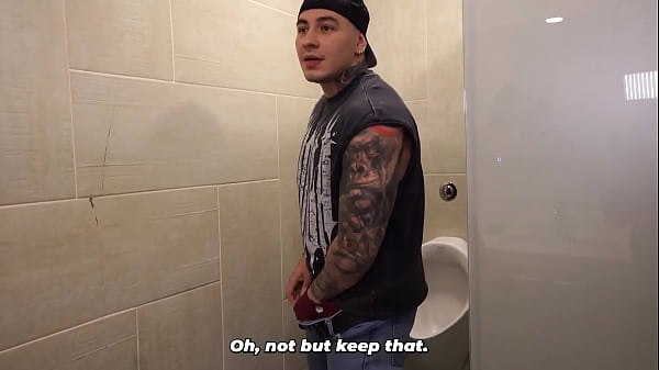Distracted busty redhead ends up in the men's bathroom and can't resist seeing a big dick