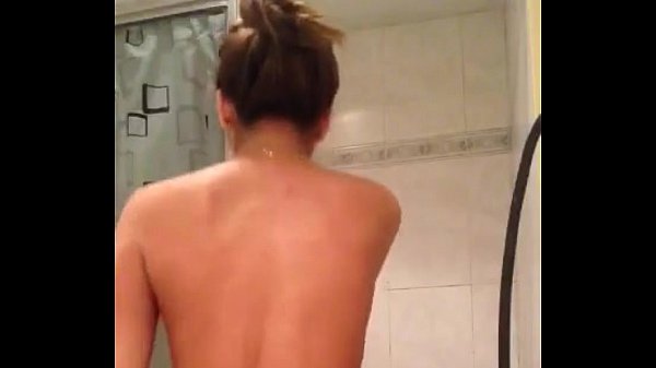Beautiful brunette dancing in the bathroom