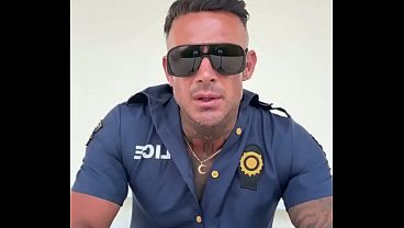 A man in police officer cosplay jerks off