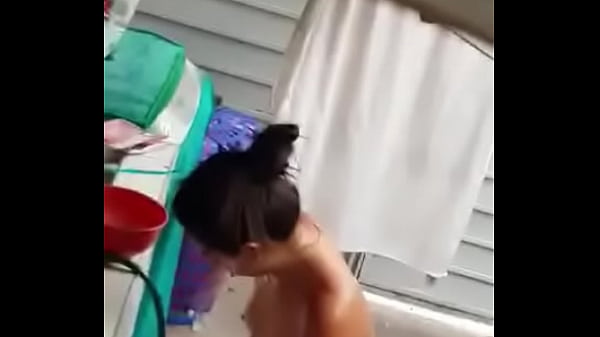 Young girl being filmed taking a shower