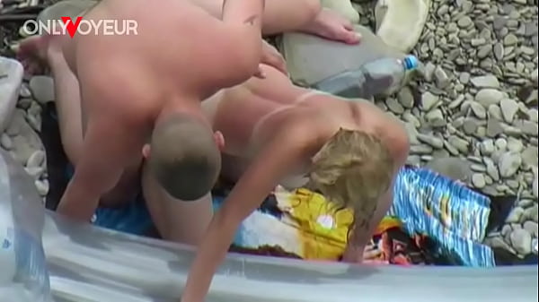 Beach Voyeur. Lucky guy getting his dick sucked while sunbathing on air mattress