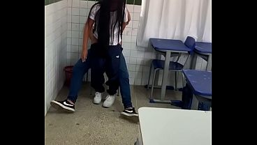 A young 18-year-old brunette was caught on camera giving a blowjob to a friend with a big, thick penis in her school classroom.