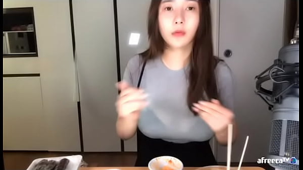 Korean babe fondling her boobs through clothes