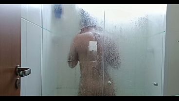Brunette having sex in the shower.