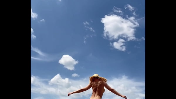 Sexy stepmother walks naked in the field