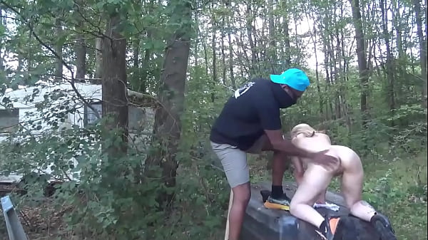 A blonde MILF gets sodomized by the lake by two big dicks from the BBC !