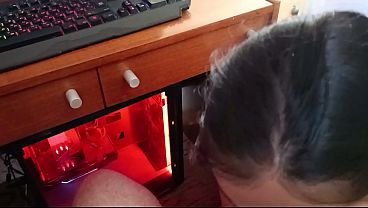 Stepmom sucks her nerdy stepson while he's playing on the computer