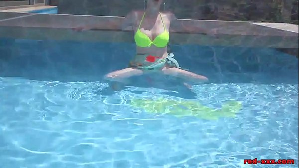 Mature redhead Red XXX masturbating in the pool
