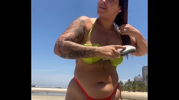 Married woman attracting attention on the beach with a stiletto bikini