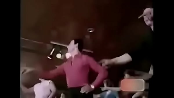 He picks up the microphone and starts singing