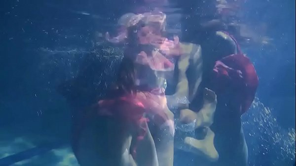 Two hot lesbians underwater touching each-other. y. s are naked in the pool. Young nudists ..