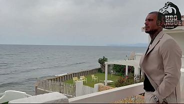 A muscular businessman jerks off in his beachfront villa