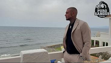 A muscular businessman jerks off in his beachfront villa