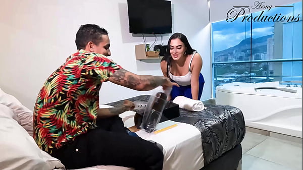 The cleaning girl helps him with his new toy by sucking him