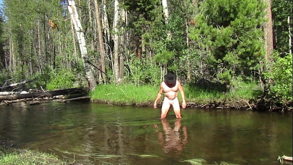 Bathing naked in the creek.