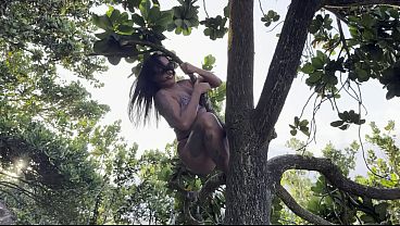 A hot chick climbing a tree and rubbing her butt against the trunk.
