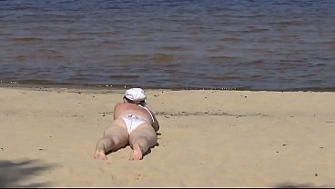Nimble mature mommy has fun with young guys on the beach 2