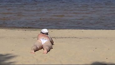 Nimble mature mommy has fun with young guys on the beach 2