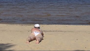 Nimble mature mommy has fun with young guys on the beach 2