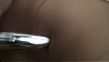 The bored office worker masturbates with a vibrator through her pantyhose while smoking lasciviously.