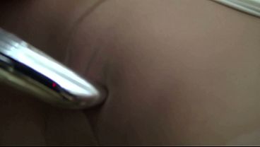 The bored office worker masturbates with a vibrator through her pantyhose while smoking lasciviously.