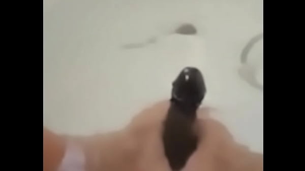 Milf plays in the tub with a big dildo