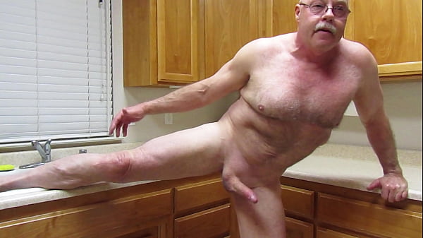 Naked stretching in the kitchen