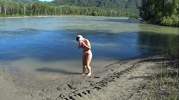 Lesbians rest and fuck on the river bank. Girlfriend with a hairy pussy in a swimsuit doggystyle shakes a big butt. POV Outdoors.