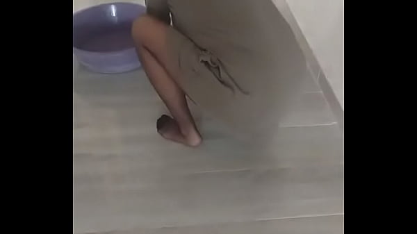 Mature woman in turbanli nylon stockings wipes floors