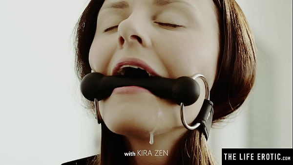 A gag in her mouth and her fingers in her pussy as she orgasms