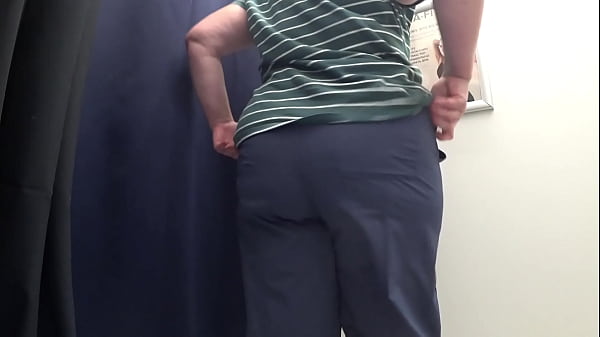Big ass in white panties in the fitting room tries on tight leggings, while the camera watches. Chubby milf. PAWG close-up.