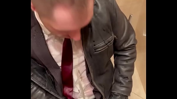 Office boss in Suit pissing on office boy in su...