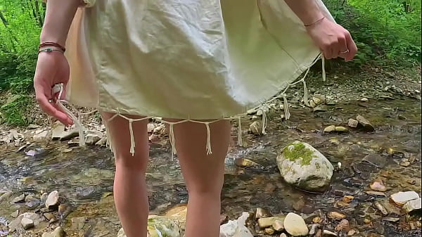 Naked girl walks in the stream and masturbates passionately