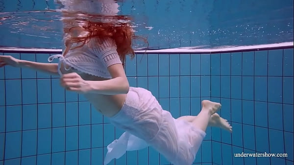Redhead Marketa in a white dress in the pool