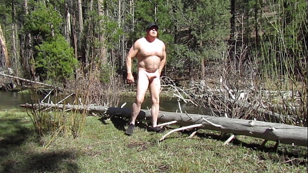 Naked on a log at the creek.