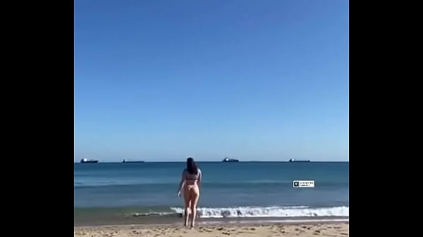 GIRL WALKING ON THE BEACH