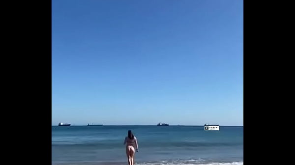 GIRL WALKING ON THE BEACH