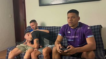 Well-endowed men fucking a naughty twink playing video games.