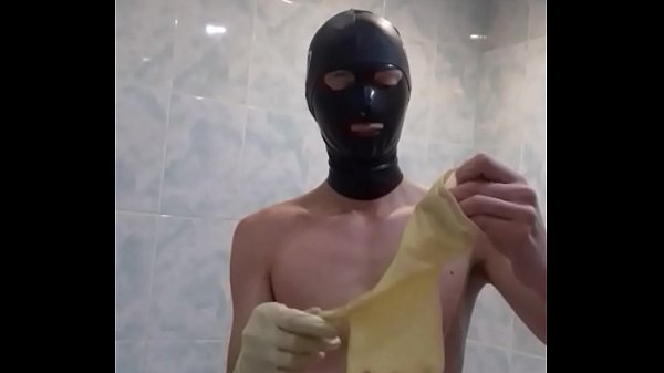 Guy wanks in condom and medical gloves