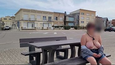 A busty mom exposes her big saggy boobs in the street.