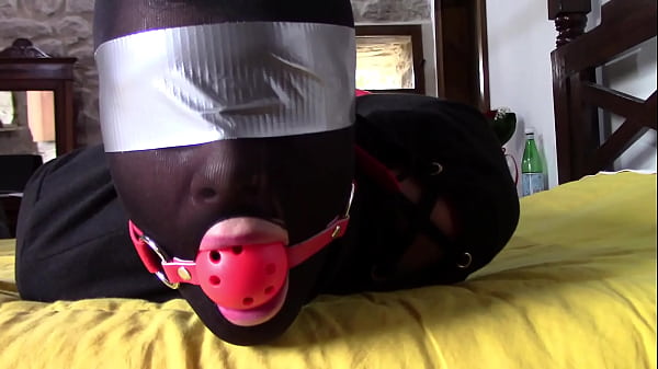 Laura XXX is wearing panthyhose and high heels. She's hogtied, masked, blindfolded and ballgagged