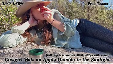 "Cowgirl Eats an Apple Outside in the Sunlight"